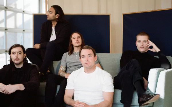 HD desktop wallpaper featuring the band Deafheaven casually posed on a couch, suitable as a background for fans.