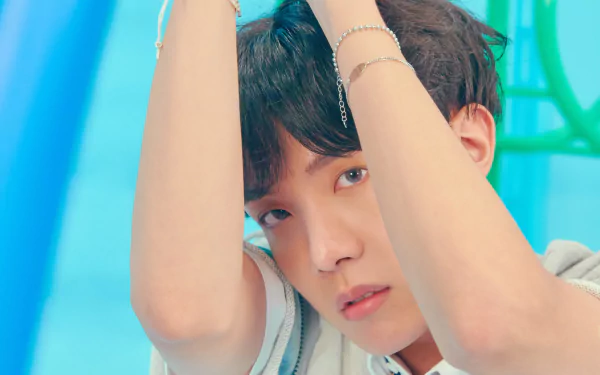 Close-up 4K Ultra HD wallpaper of J-Hope (Jung Hoseok) from BTS, showcasing the K-pop singer in a vibrant, colorful setting.