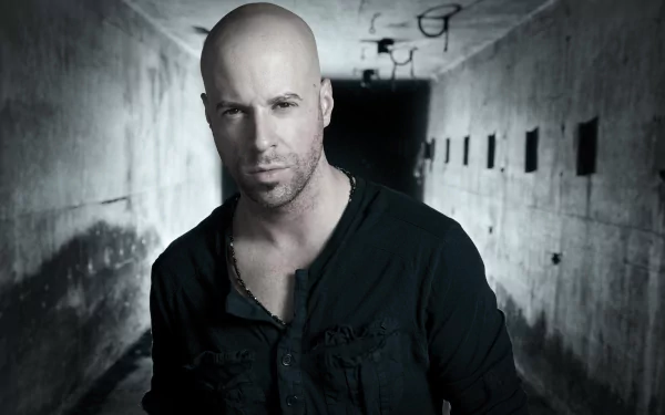 A man standing in a dimly lit tunnel, featured as an HD desktop wallpaper.