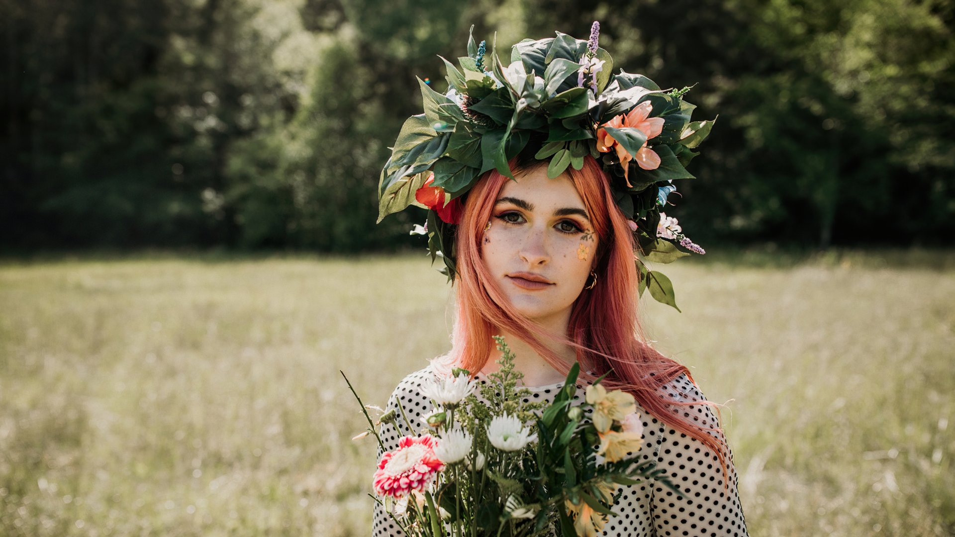 Woman with floral wreath and bouquet standing in a field, HD Spiritbox themed desktop wallpaper.