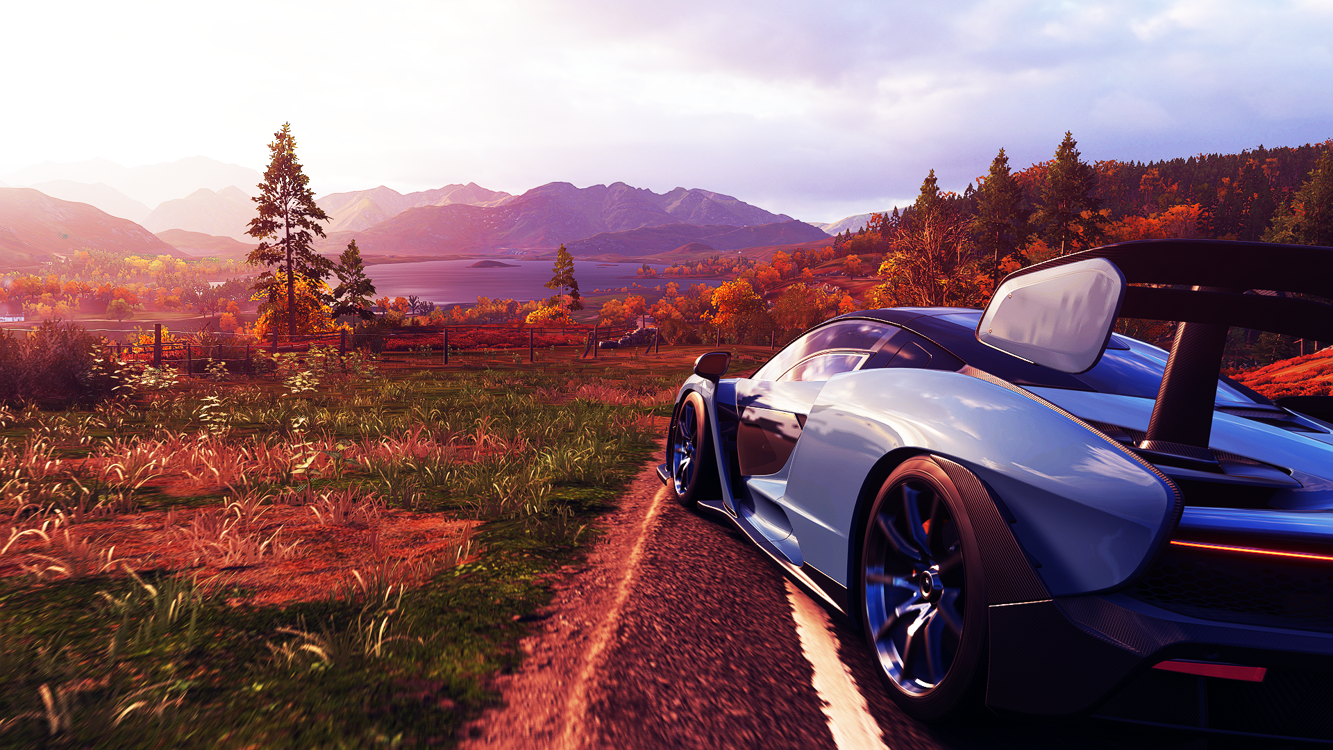 Forza Horizon 4 HD PC wallpaper: sleek supercar on a sunlit country road, autumn foliage and distant mountains in a vibrant Forza video game scene.