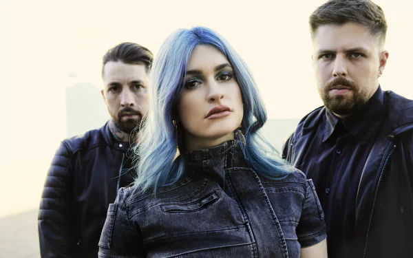 A striking HD wallpaper featuring the band Spiritbox, showcasing three members with intense expressions against a soft background, embodying the spirit of their music.