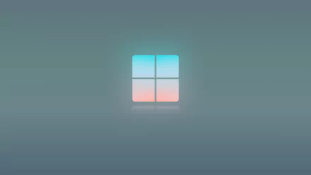 4K Ultra HD desktop wallpaper showcasing a minimalist Windows 11 logo with soft blue and pink gradient on a smooth gray background.