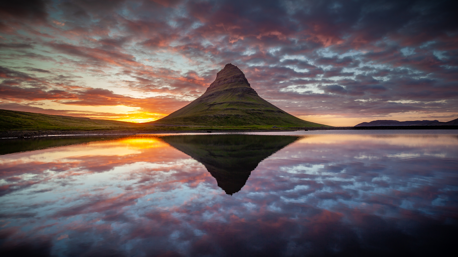 Reflections of Kirkjufell with the midnight sun by Hughie O'Connor