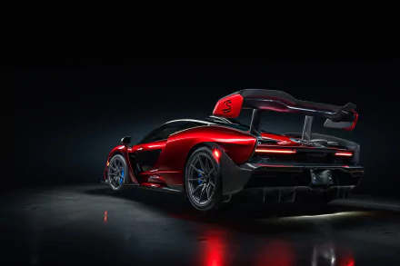 HD desktop wallpaper featuring a striking red McLaren Senna supercar with sleek aerodynamic design, showcased against a dark background.