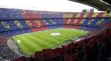 HD PC wallpaper of FC Barcelona’s stadium filled with fans displaying a colorful mosaic during a sports event.