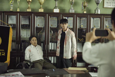 All of Us Are Dead (TV show) scene: bloodied student stands in a trophy-lined school office beside a seated man while someone photographs them — HD PC desktop wallpaper/background