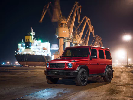 A red Mercedes-Benz G-Class vehicle parked at a dockyard at night, captured in a 4K Ultra HD PC desktop wallpaper and background.