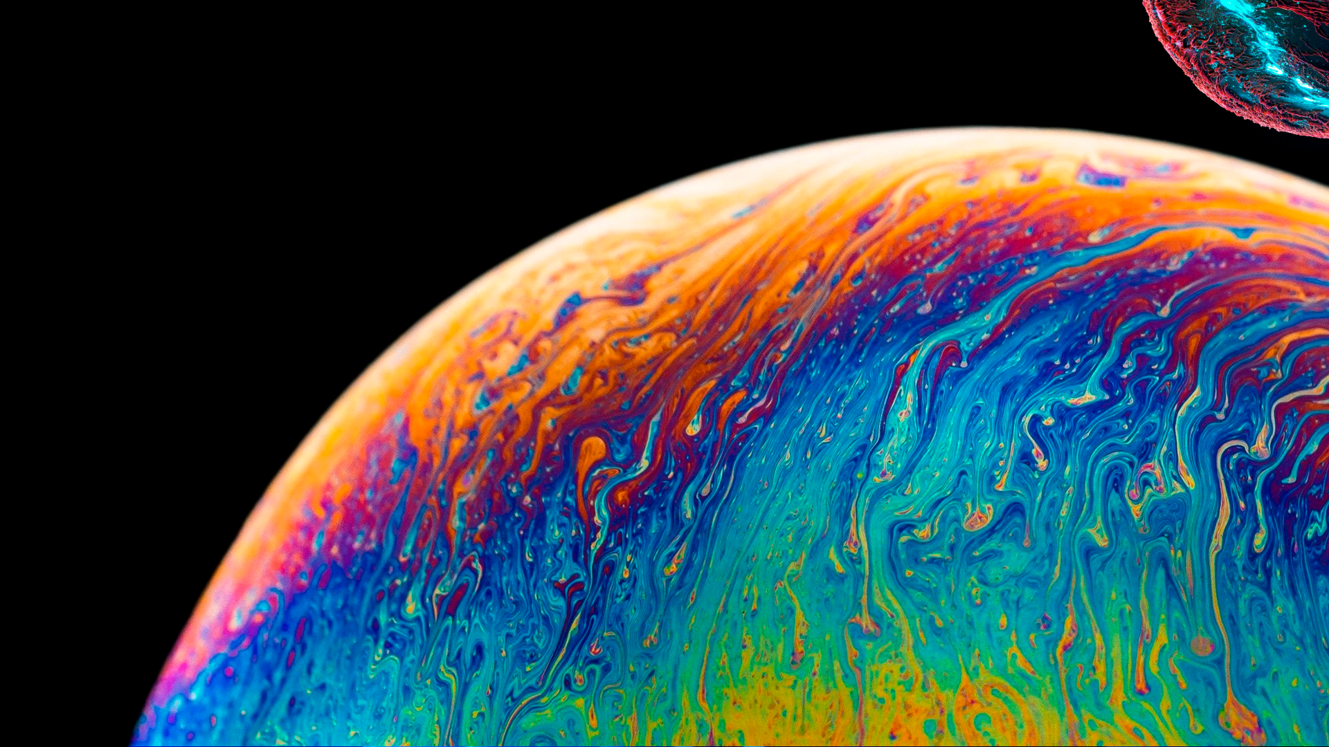 Vibrant swirls of blue, orange and purple form a soap-bubble, planet-like curve against black space — 4K Ultra HD PC desktop wallpaper and background.