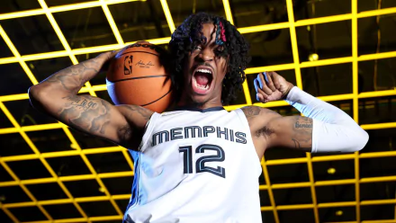 HD sports desktop wallpaper: roaring basketball player in Memphis #12 jersey holding ball over shoulder against a yellow neon grid ceiling backdrop.
