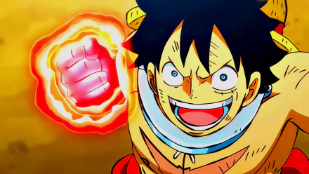 HD PC desktop wallpaper: Anime portrayal of Monkey D. Luffy from One Piece's Wano arc, grinning as a fiery red fist glows against a warm golden background.