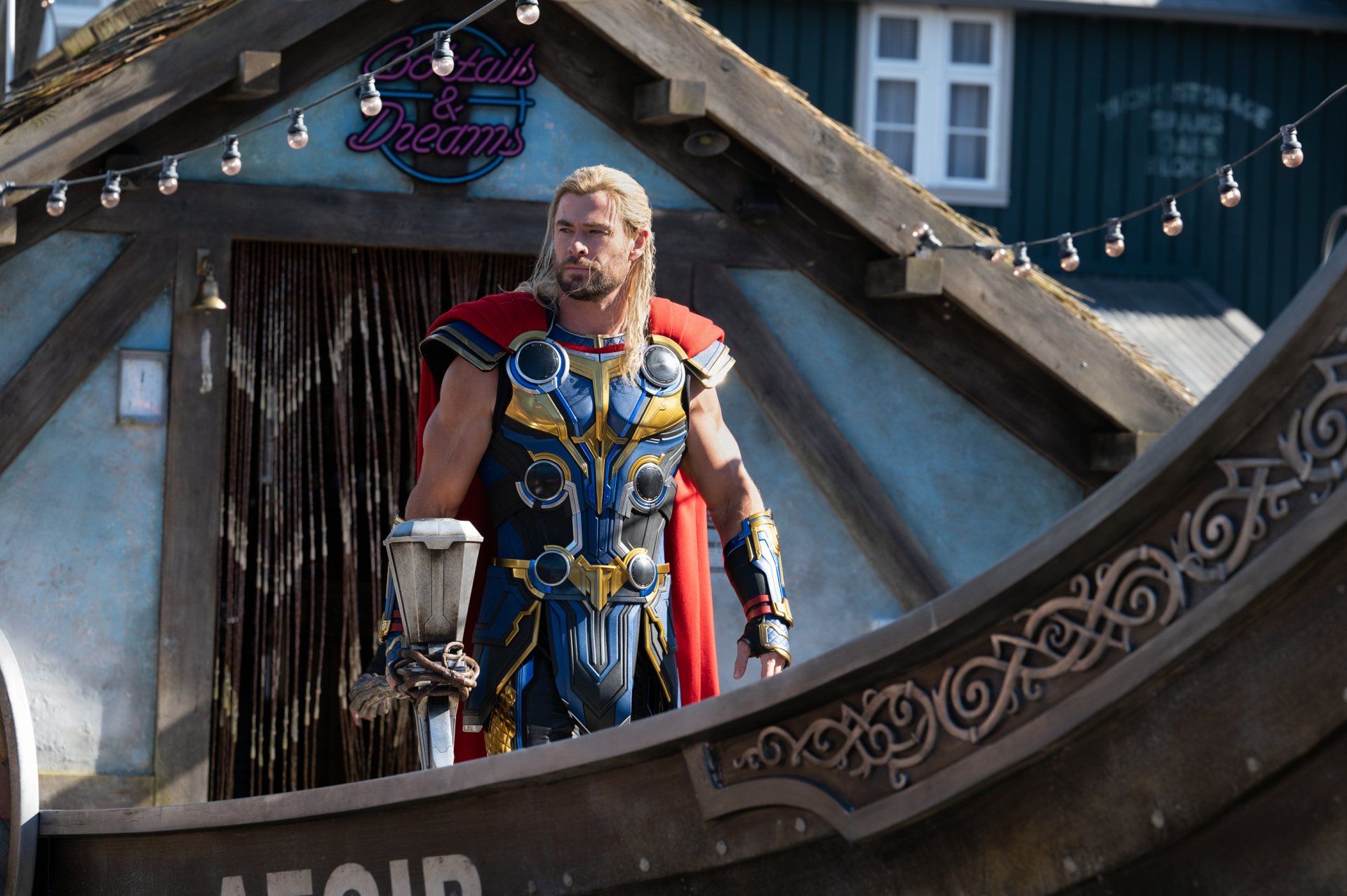 4K Ultra HD PC wallpaper: Thor in ornate blue-and-gold armor with red cape stands on a ship balcony — cinematic still from the movie Thor: Love and Thunder.