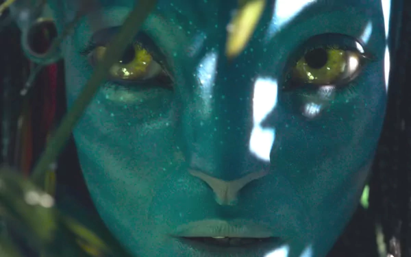 Close-up HD desktop wallpaper of Neytiri from the movie Avatar: The Way of Water, showcasing her detailed facial features and glowing yellow eyes.