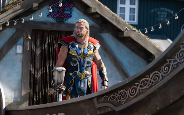 4K Ultra HD PC wallpaper: Thor in ornate blue-and-gold armor with red cape stands on a ship balcony — cinematic still from the movie Thor: Love and Thunder.