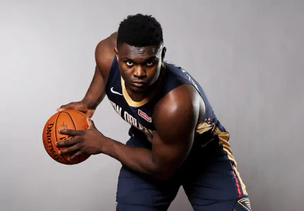 High-definition desktop wallpaper featuring a professional basketball player poised with a basketball, showcasing athletic intensity, wearing a navy and gold jersey.