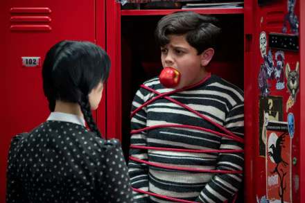 HD PC desktop wallpaper featuring Issac Ordonez as Pugsley tied with red rope in a red locker, from the TV show Wednesday.