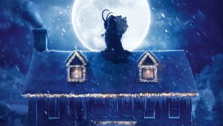 HD desktop wallpaper featuring a snowy house with holiday lights beneath a large full moon, inspired by the movie Krampus.