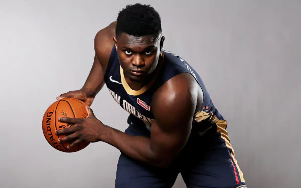 High-definition desktop wallpaper featuring a professional basketball player poised with a basketball, showcasing athletic intensity, wearing a navy and gold jersey.