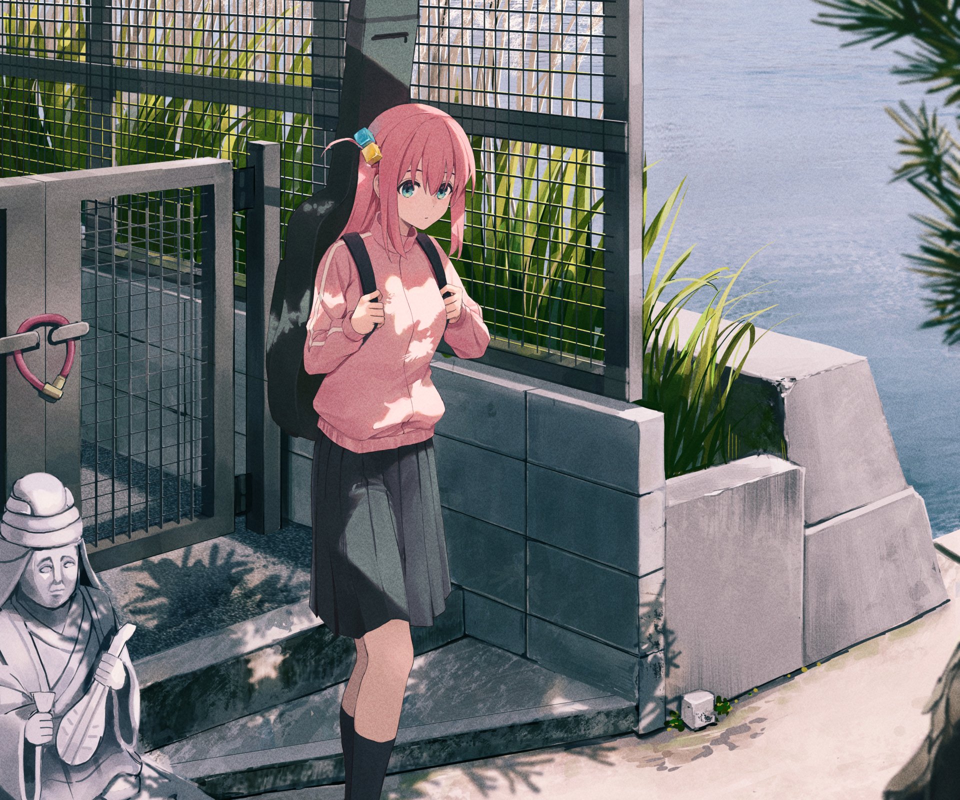 Hitori Gotou from Bocchi the Rock! stands near a riverside fence, wearing a pink sweater and black skirt in this HD anime desktop wallpaper.