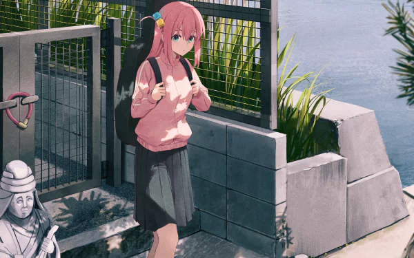 Hitori Gotou from Bocchi the Rock! stands near a riverside fence, wearing a pink sweater and black skirt in this HD anime desktop wallpaper.
