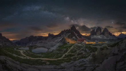 Night view of the Milky Way above the Tre Cime di Lavaredo peaks in the Dolomites, captured in a stunning HD desktop wallpaper showcasing nature's beauty.