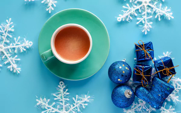 A cozy HD desktop wallpaper featuring a steaming cup of hot chocolate, perfect to warm up your screen in the winter season.