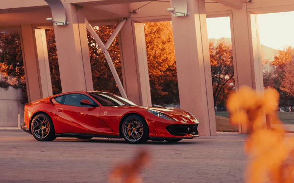 Red Ferrari 812 Superfast parked under concrete beams at sunset, rendered as a 4K Ultra HD PC desktop wallpaper and background.