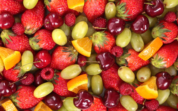 A vibrant HD desktop wallpaper featuring an assorted mix of delectable, fresh fruits.