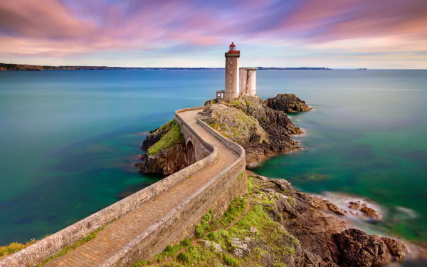 A stunning lighthouse showcased on an HD desktop wallpaper, with the ocean in the background, created by man.