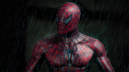 A high-definition desktop wallpaper featuring Spider-Man standing in the rain, emphasizing the intricate details of his suit in a dark and dramatic setting.