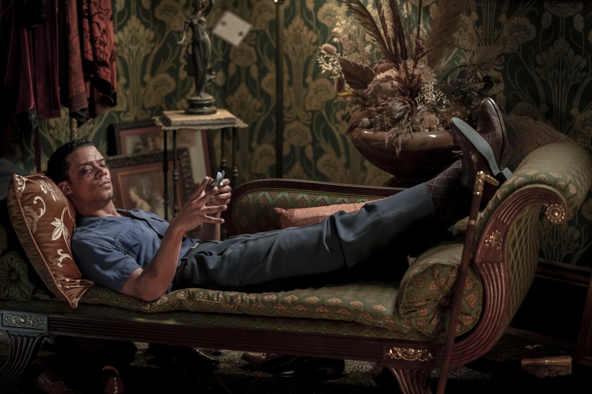 HD wallpaper featuring a character from Interview with the Vampire relaxing on a vintage chaise lounge in an opulently decorated room.