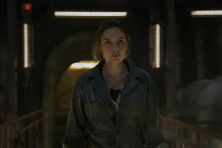 HD wallpaper featuring a woman in a dimly lit industrial corridor, creating an atmospheric background for desktops.