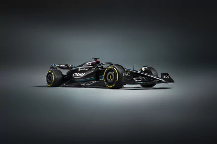 A sleek Mercedes W14 Formula 1 vehicle stands out against a dark background, showcasing its aerodynamic design in this high-definition desktop wallpaper.