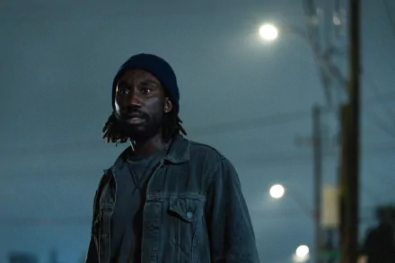 HD wallpaper featuring a man with a solemn expression wearing a beanie and jacket at night with street lights in the background, tagged as Culprits.