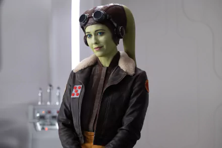 HD desktop wallpaper featuring a character resembling Hera Syndulla from the Star Wars series, wearing pilot goggles and a flight jacket, with a soft-focused background.