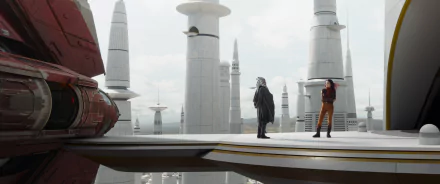 A dramatic scene from the TV show *Ahsoka* (2023) featuring two characters standing on a futuristic platform surrounded by towering spires and a sleek spaceship.