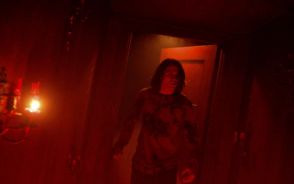 A character steps through a dimly lit hallway featuring a glowing red door, evoking the eerie atmosphere of *Insidious: The Red Door*. This image serves as a striking HD wallpaper.