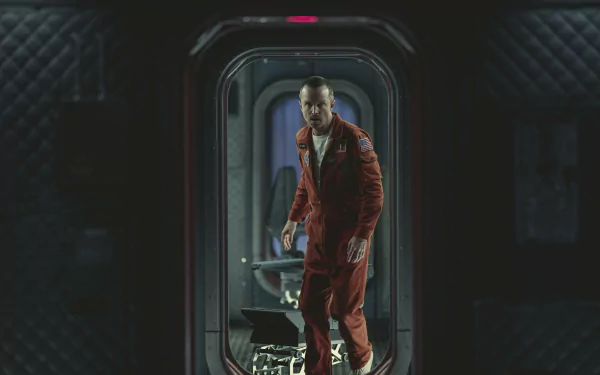 HD desktop wallpaper of a man in a red spacesuit standing inside a futuristic spacecraft, evoking the style of 'Black Mirror'.