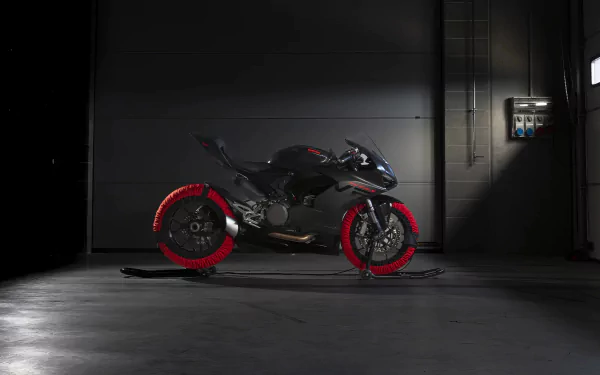 Ducati Panigale V2 motorcycle displayed as HD desktop wallpaper with a dark, industrial background setting.