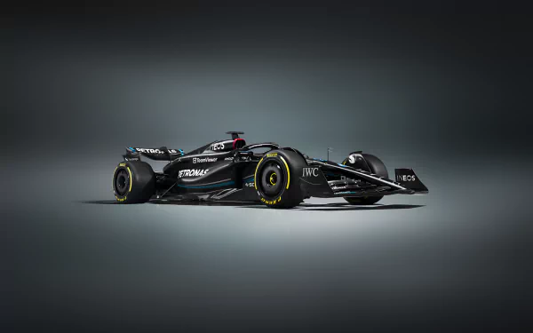 A sleek Mercedes W14 Formula 1 vehicle stands out against a dark background, showcasing its aerodynamic design in this high-definition desktop wallpaper.