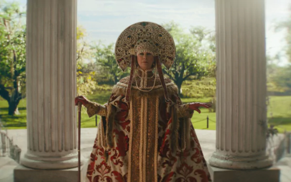HD desktop wallpaper featuring Jamie Lee Curtis in an ornate costume from the movie Haunted Mansion, posed between white pillars with a scenic garden background.