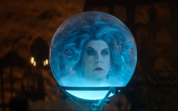 HD desktop wallpaper featuring a scene from Haunted Mansion with a character's face dramatically illuminated inside a crystal ball.