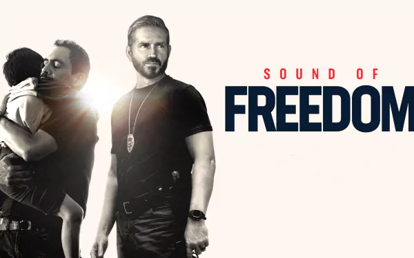 HD desktop wallpaper for the movie Sound of Freedom featuring two men, one comforting a child and the other in tactical gear.