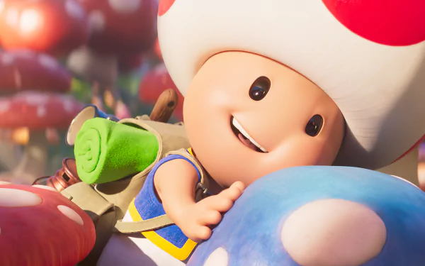 HD desktop wallpaper featuring Toad from the 2023 movie Super Mario Bros., playfully lying on colorful mushrooms.