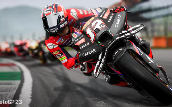 HD desktop wallpaper from MotoGP 23 featuring a dynamic scene of a motorcycle racer leaning into a sharp turn on the racetrack.