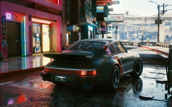 Cyberpunk 2077 HD desktop wallpaper featuring a stylish car on a neon-lit street after rain, showcasing the game's futuristic urban environment.
