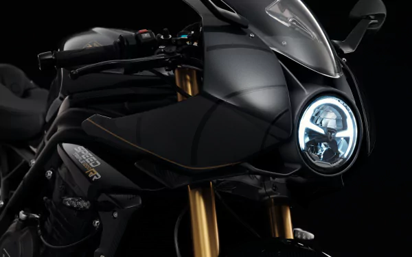 HD wallpaper featuring the sleek Triumph Speed Triple 1200 RR Bond Edition motorcycle against a dark background.