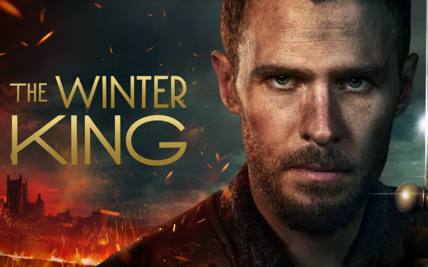 HD desktop wallpaper for 'The Winter King' featuring a close-up of a serious-looking man set against a fiery battle scene and a castle backdrop.