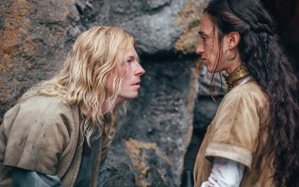 A dramatic scene from the TV show The Winter King, featuring two characters engaged in an intense exchange against a rugged backdrop. High-definition wallpaper for fans.