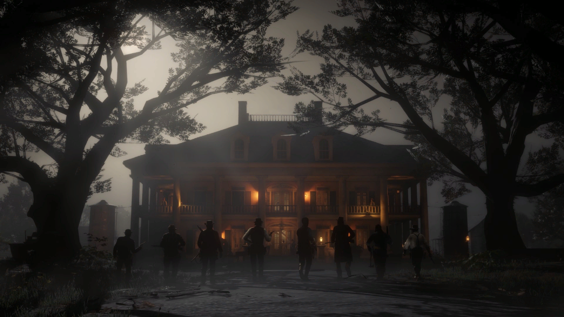 Dark, atmospheric HD PC desktop wallpaper from the video game Red Dead Redemption 2, featuring silhouetted figures approaching a grand, lit-up mansion at dusk.